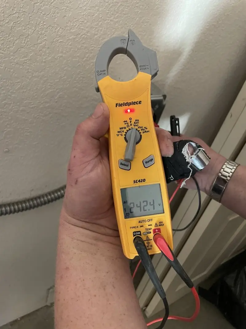 Voltage testing with clamp meter during Whole House Surge Protector in Littleton